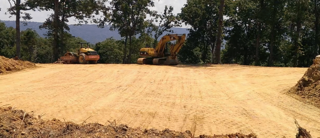 A construction site featuring a tractor and a bulldozer working on earthmoving tasks.